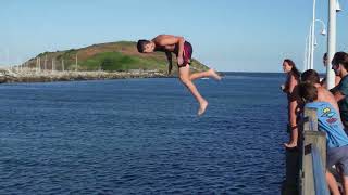 Superman Wharf JUMP Tricks diving and flips into water.