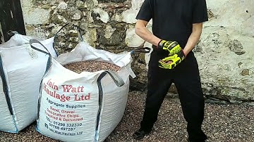 Shovelling stone from a bulk bag. Cut the bag.
