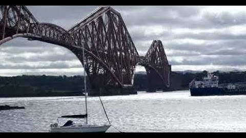 Seniority Cargo Ship By Forth Railway Bridge On History Visit To Firth Of Forth Scotland