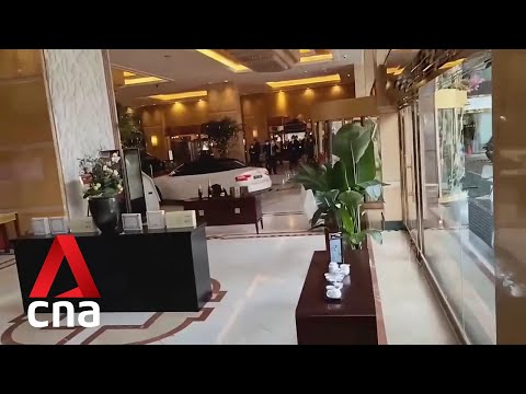 Man crashes car into hotel lobby in China