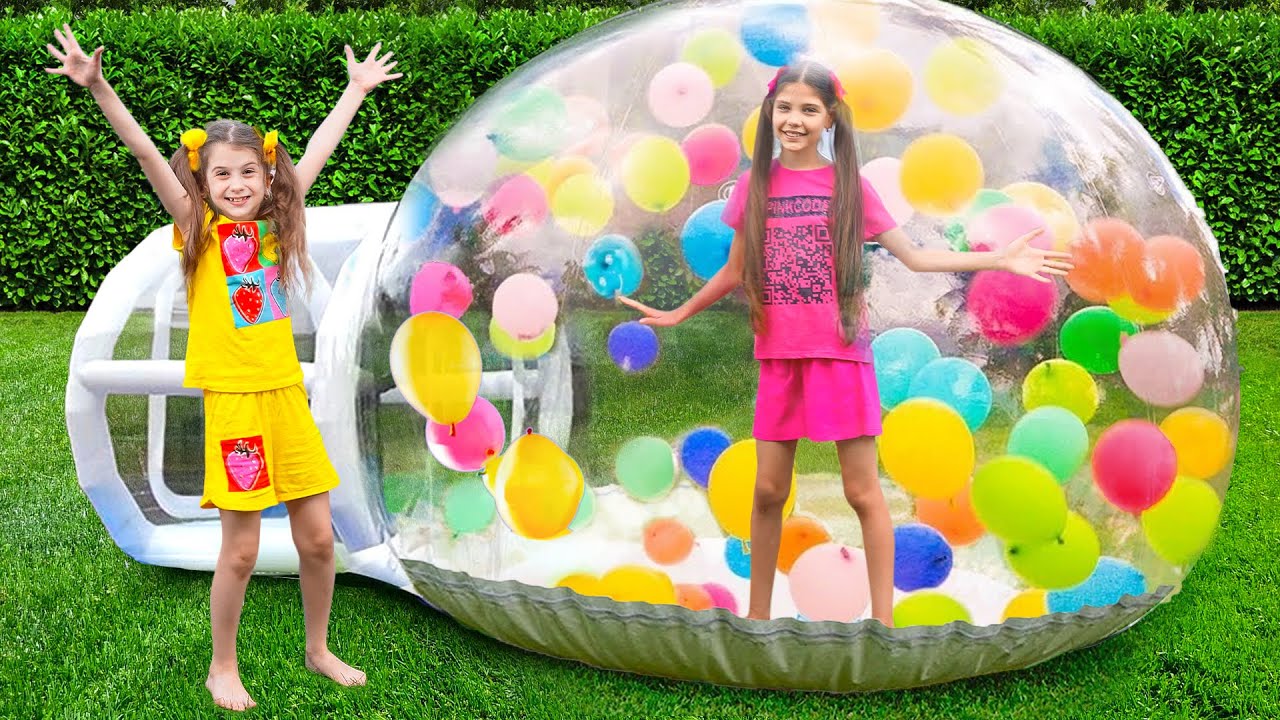 Eva and Friends play in a Huge Inflatable Ball House