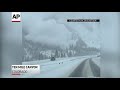 Cloud of snow blankets highway after avalanche