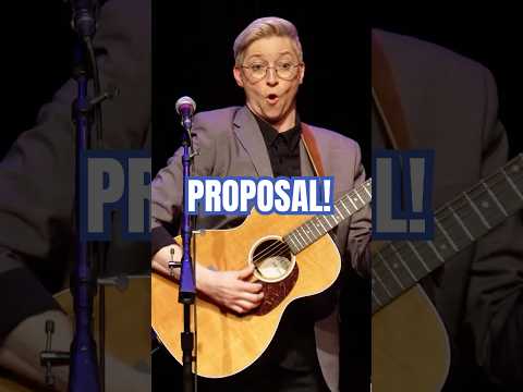 Smooth lesbian proposes during comedy show. Comedian watches hornily.