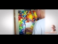 Leonid Afremov creating a painting of a couple under umbrella  - a montage clip .