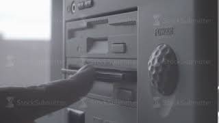 Close-up of inserting and removing an old-style 5.25" floppy disk.
