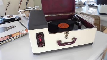 Webcor 3 speed manual portable record player playing an LP record