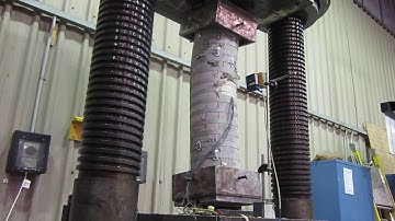 Circularized columns strengthened with steel straps under eccentric load