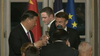 Macron and Xi toast at a state dinner at the Elysee Palace | AFP