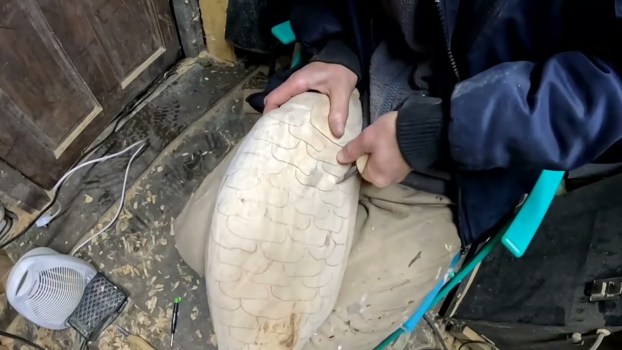 Drawing and carving carp scales.    