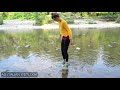 Wetlook - Giulia in the river with vintage sneakers, leggings and yellow sweater.