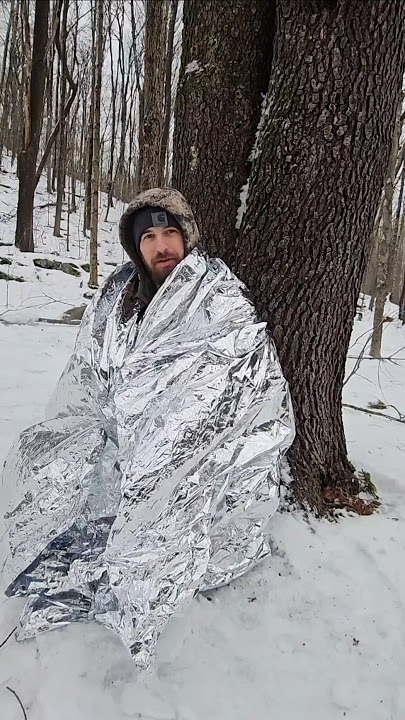 Pocket sized heated survival shelter