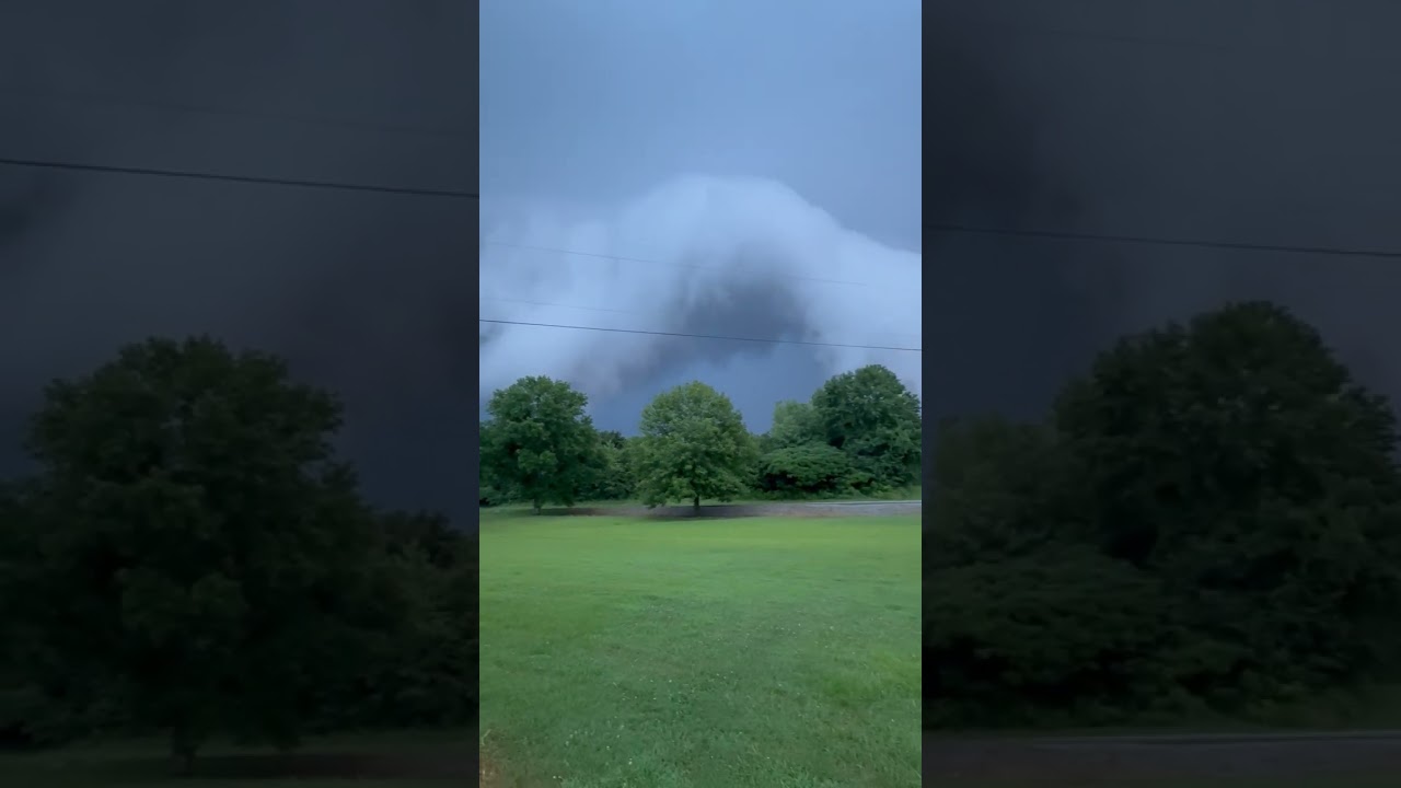 Storm Clouds Meet Golden Sunset Over Green Field