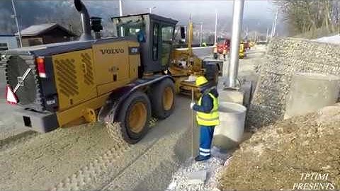 Motor Grader Grading With A Lot Of Material On The Railroad -Skilled Operator
