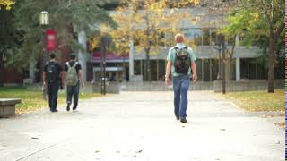 college student walking on campus zyp tqb h  D