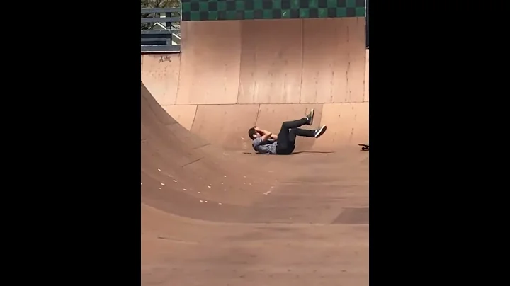 Guy tries dropping in on a skateboard ramp, but fails big time and lands on his face.