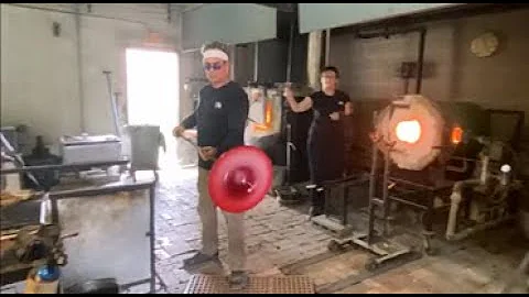 James Wilbat blowing a glass plate
