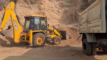 Jcb loading soil into a dump truck