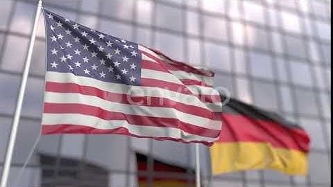 Flags of the United States and Germany in Front of a Skyscraper | Motion Graphics - Envato elements