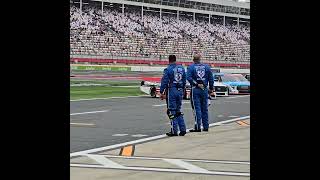 NASCAR Truck Series crewmembers honor Kyle Busch with a bow as his truck leaves pit road