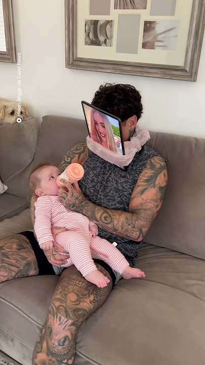 Dad outsmarts baby while feeding