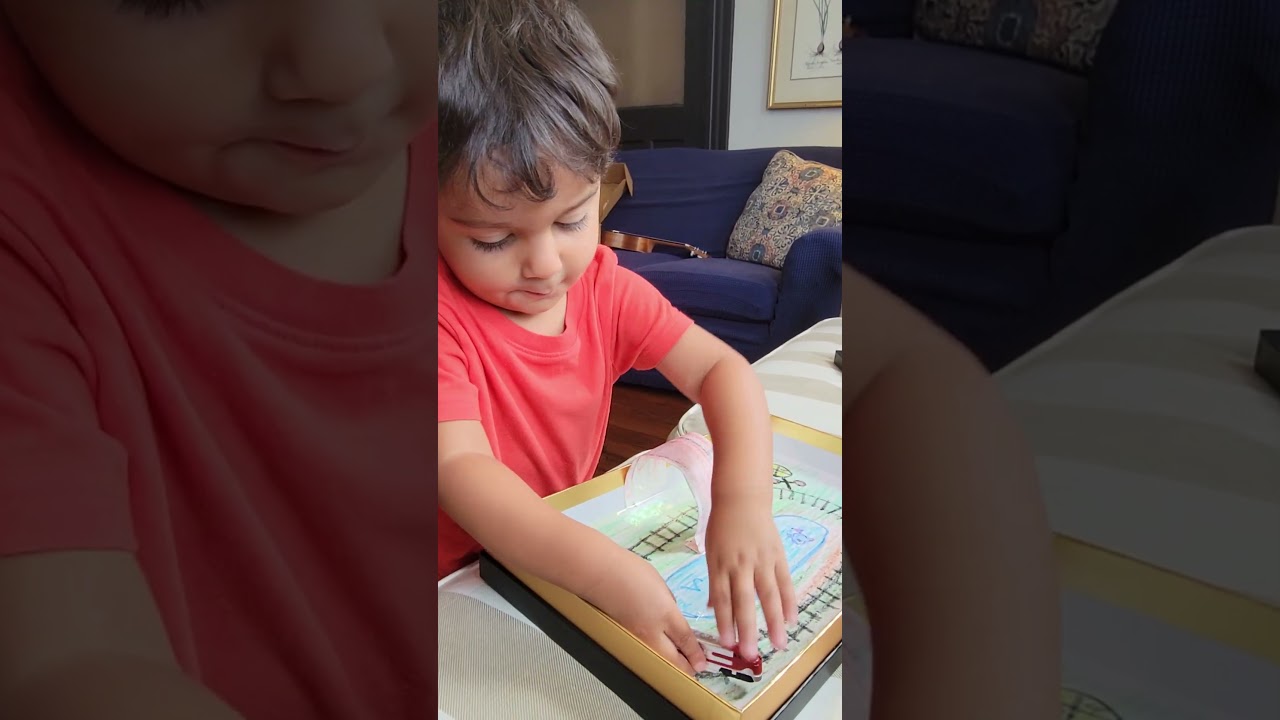 William, engaging in imaginative play, gets frustrated when his train disconnected