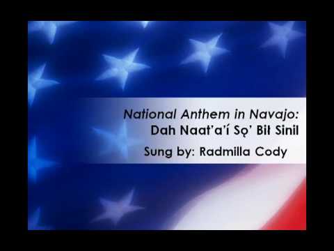 This is the lyrics, in the Navajo language, to our nation's National Anthem, "The Star-Spangled Banner." It was originally a poem by Francis Scott Key written in 1814. It was later set to music by John Stafford Smith. The song presented here is sung by Radmilla A. Cody, former Miss Navajo Nation (1997-1998) and recording artist. This song is available on her album entitled "Within the Four Directions." The lyrics here are not only intended to teach the song, but to alsohelp learn the meaning of the words to the song. Again, a translation of the Navajo word or words in English is written below each word. This is just but one version of translation in that one Navajo word can mean many different things when translated to English. To all the soldiers who are stationed here in the US or overseas, may God bless you and may this song bless you wherever you are. I hope this song adds to your celebrations this 4th of July.