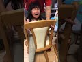 Little girl’s legs stuck in a chair