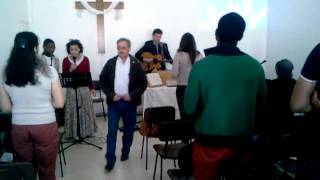 Vitor leading a song for tithes & offerings