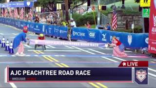 Winner Daniel Romanchuk crosses the finish line at the AJC Peachtree Road Race