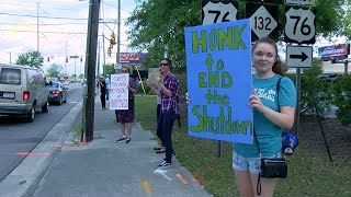 Dozens protest at busy Wilmington intersection to Reopen North Carolina
