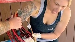 Woman Gets her arm Stuck While Rolling Electric Cord in Loop