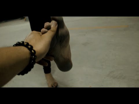 Loulou barefoot in the underground garage