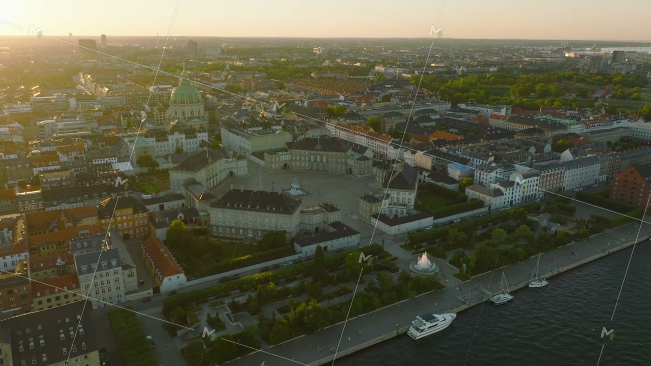 Amalienborg palace, royal residence and famous Frederiks Kirke against sunset. Aerial slide and pan