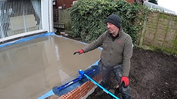 Finishing the concrete slab using the fresno!
