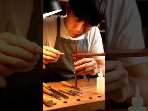 Carpenter making a miniature teacher desk.