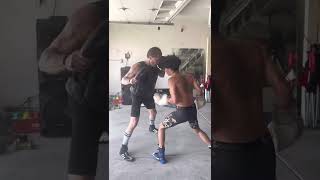 Paul Spadafora doing pad work with his amateur fighter Fhennixx