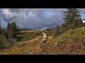 Hunter walking through alaska with rifle