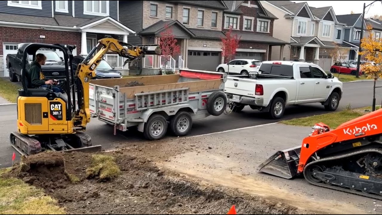 Kubota SCL1000 and CAT 301.7 mini ex on a paver walkway base prep job.