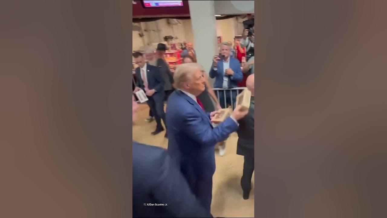 Trump throws chicken into crowd at football game
