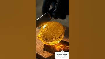 Ultra close-up ASMR of a sharp knife slowly slicing into a fresh, textured lemon-capture the