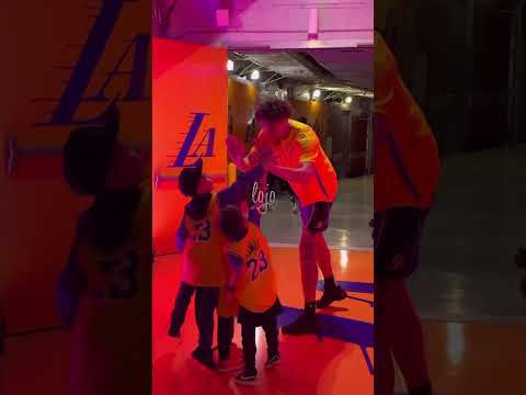 Lakers players greeting young Lakers fans after defeating the 76ers