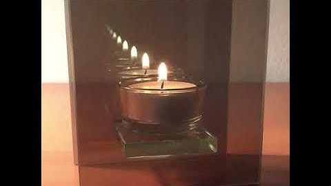 Infinity Mirror  Tea-light candle parallel partially mirrored panes of glass create🪞.#short video