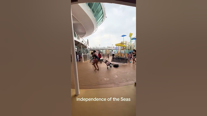 Royal Caribbean cruise ship passengers run for cover as storm batters deck furniture
