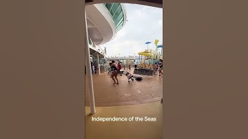 Thumbnail of Royal Caribbean cruise ship passengers run for cover as storm batters deck furniture