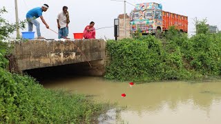 Fishing Video || Boy and girl are fishing together using hooks in a canal beside the national road