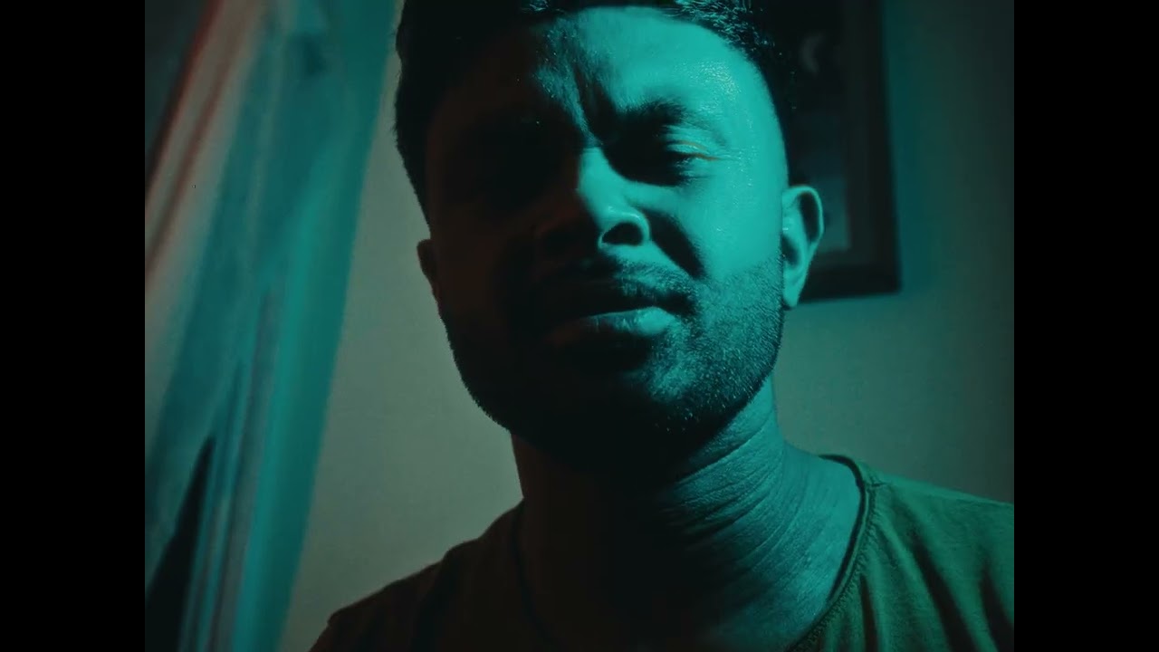 Anthony Regala in a teal-lit close-up from So Long