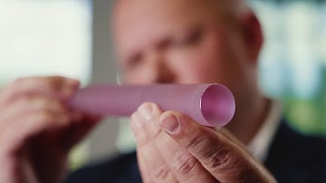 A glass that amplifies light by stimulating radiation emissions