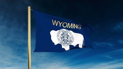 4K wyoming flag slider style with title. Waving in the wind with cloud background animation Stock