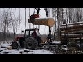 Logging with MTZ 952.3+Kesla trailer in winter forest.