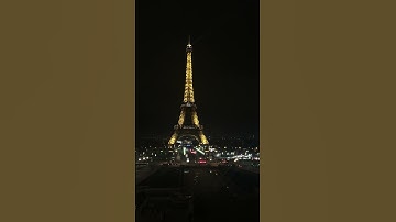 Night-time views of illuminated Eiffel Tower Paris at night.